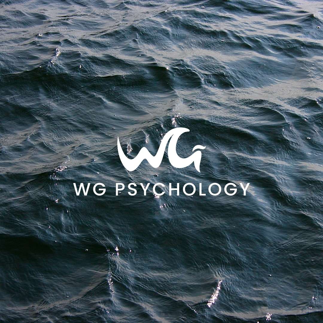 WG Psychology logo with wave-inspired lettering placed over a photograph of ocean water