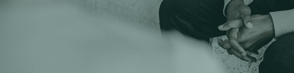 Close-up of a person’s hands resting during a therapy session, used as WG Psychology website hero image.