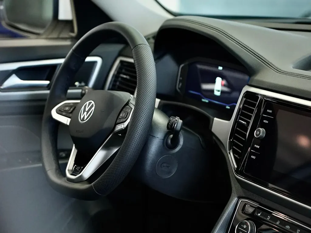 Close-up of Volkswagen interior highlighting the steering wheel and premium design details