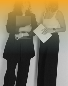 Brand Clarity Worksheet cover image of two women standing near one another holding laptops, and a yellow hue overlay on the top portion of the image covering part of the black and white image