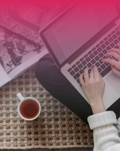 Marketer working on a laptop creating a high-converting landing page for paid ads, illustrating landing page best practices for ad campaigns.