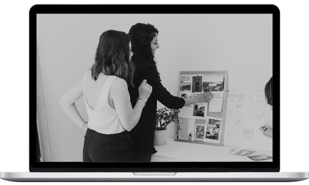 Two members of the Fierce Media creative team collaborating on a visual mood board and marketing strategy for automotive and wellness clients.