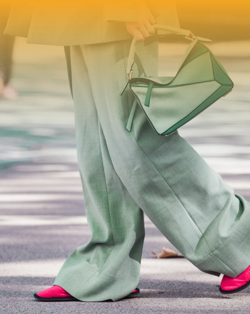 Business owner walking into a networking event wearing comfortable outfit and carrying a handbag, highlighting preparation and confidence for professional networking